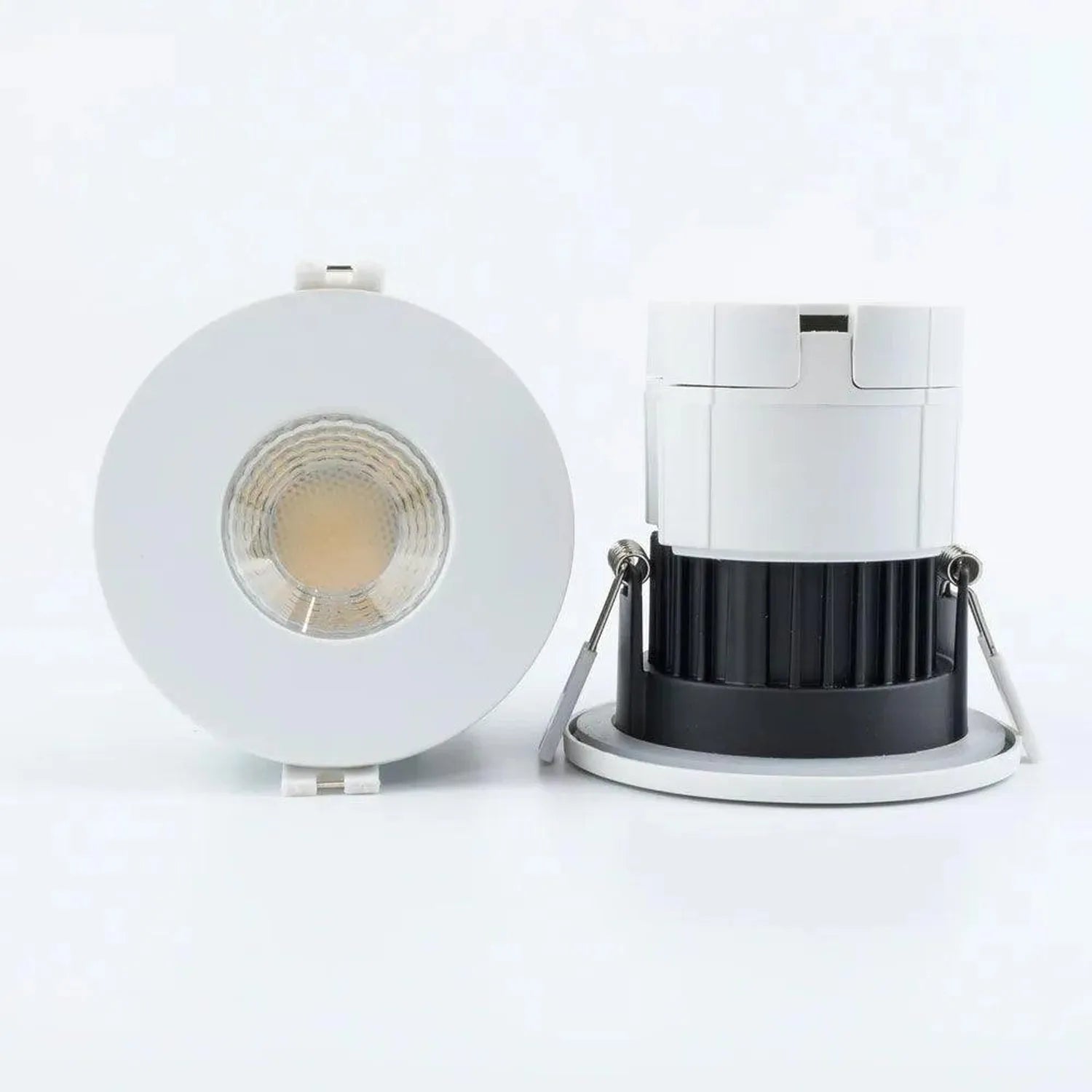 Front and side view of white recessed LED downlight with visible COB lens and separate white trim ring with black heat sink d