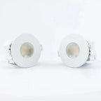 Pair of white recessed LED downlights with circular trim rings and visible lamp heads, displayed against a light background.