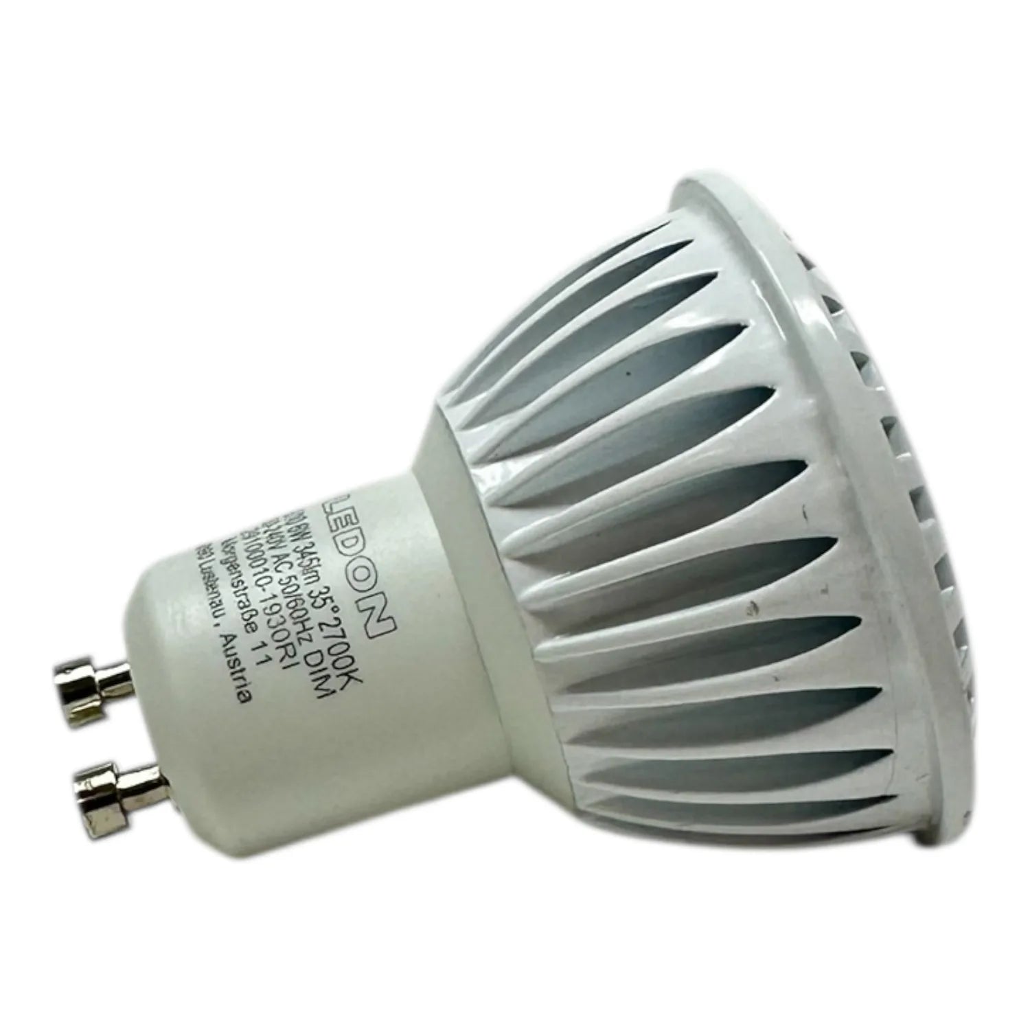 White LED GU10 spotlight bulb with ribbed heat sink and brass pin connectors, shown against white background.