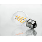 LED filament bulb with warm white glowing filaments inside clear glass globe, metallic E27 screw base, product shot on white 