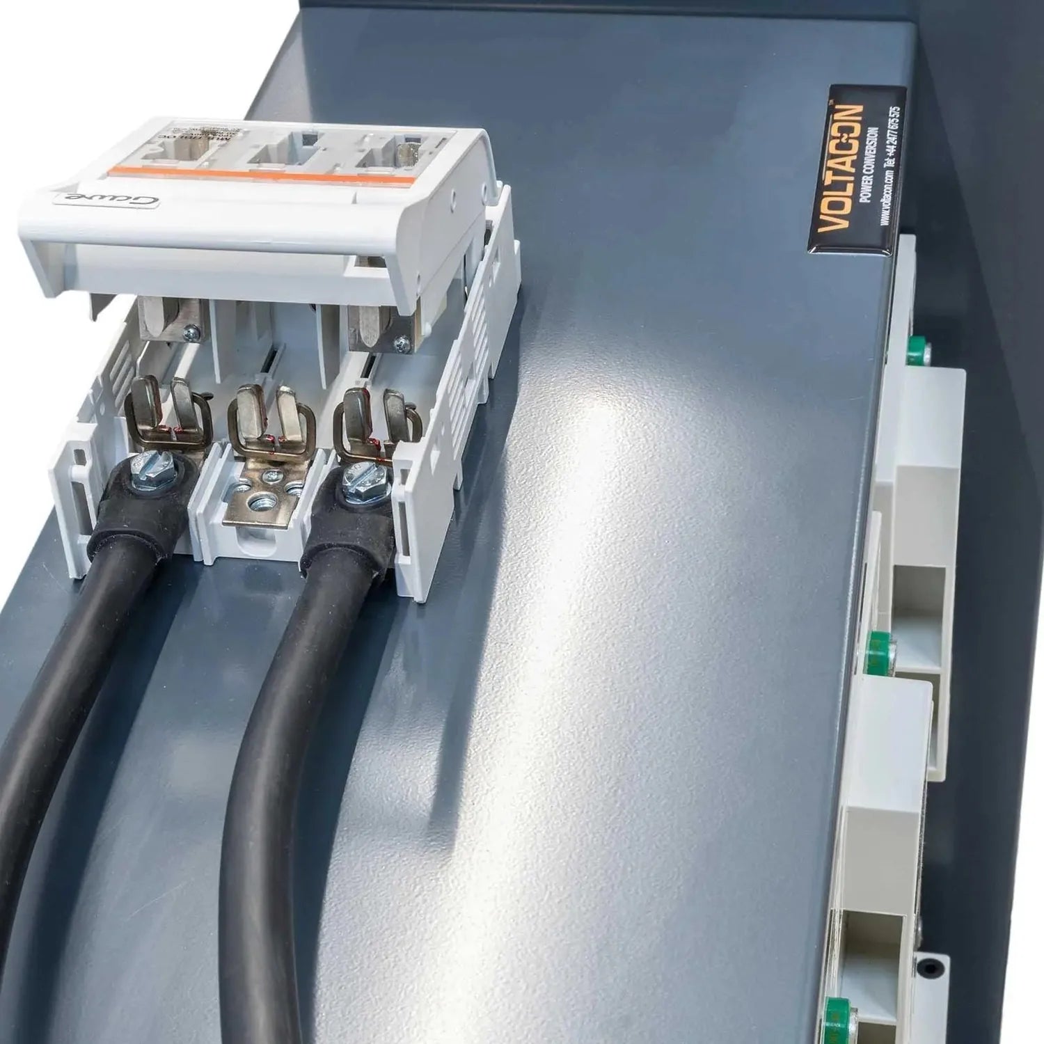 Hoppecke battery installation showing white terminal connector block with three metal terminals connected to black cables, mo