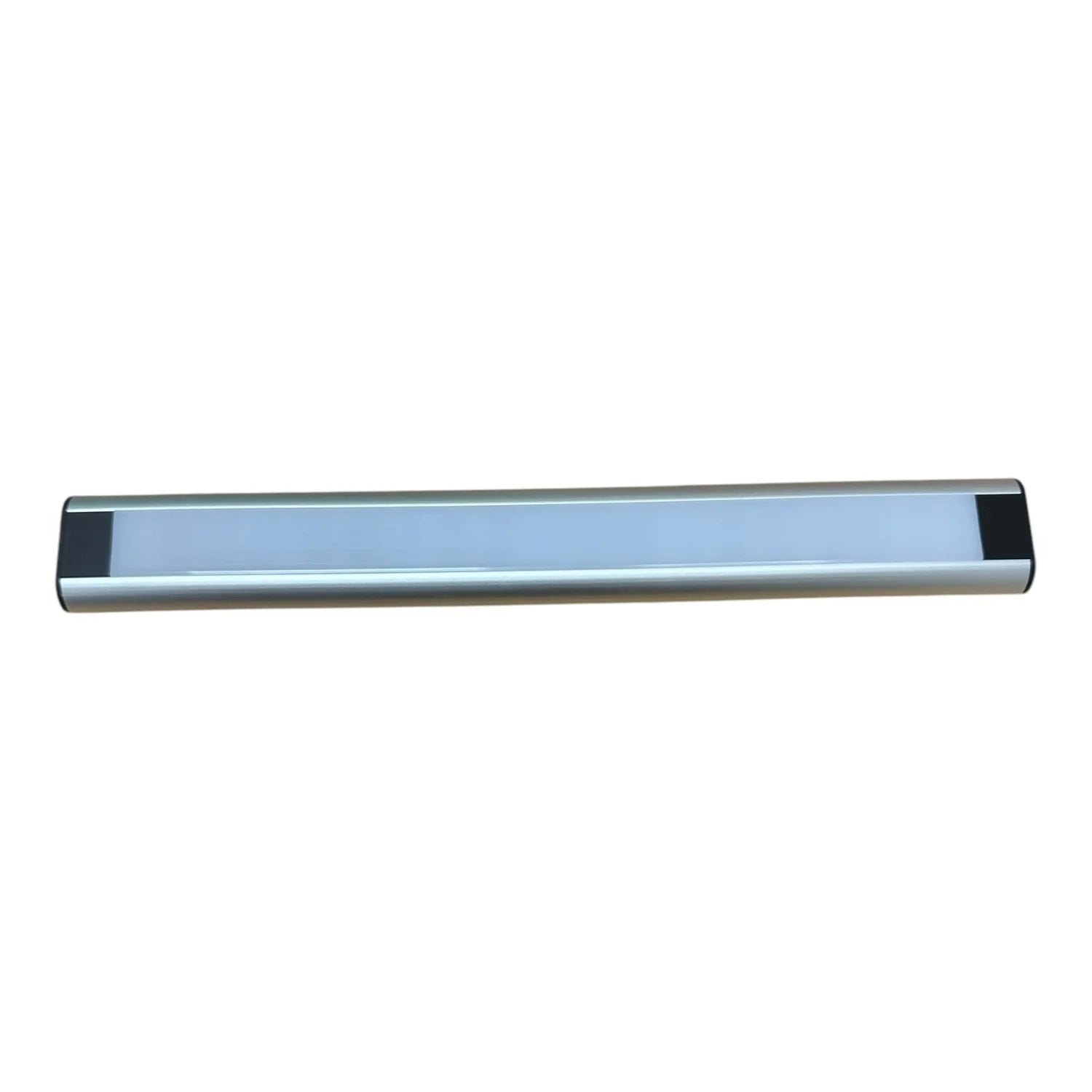 LED cabinet light strip with silver aluminum body and frosted diffuser, viewed against white background.