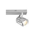 Chrome cylindrical spotlight fixture mounted on rectangular track rail, lit bulb visible in front-angled position.