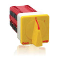 Yellow and red DC switch isolator with red handle on DIN rail mounting block, front view of product.
