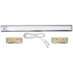 Battery-powered LED under cabinet light kit with motion sensor, white cord, and two adhesive mounting brackets.