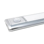 Silver LED under-cabinet light with white dome motion sensor, angled product shot on white background.