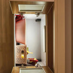 Interior view of open cabinet displaying LED under-cabinet light with geometric wooden diffuser and yellow LED glow among dec