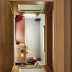 Interior view of under-cabinet LED light installed in wooden storage box, showing warm illumination and decorative items insi