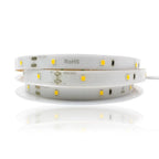 Coiled white LED strip light with yellow SMD components, marked RoHS and +DC24V, displayed against white background.