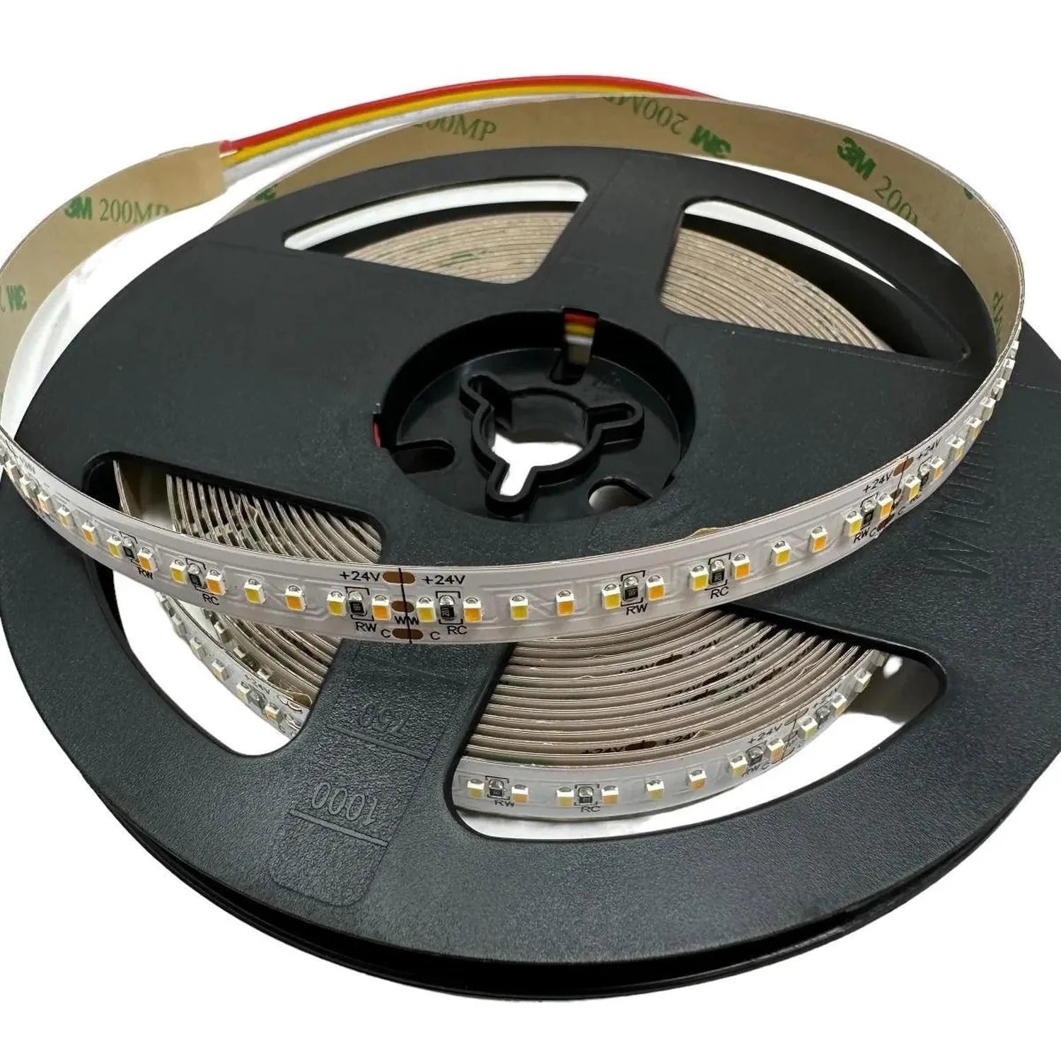 Coiled LED strip light on black reel showing warm white SMD LEDs, 24V connection points, and rainbow-striped adhesive tape ba