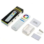 Mi-Light RGB+CCT LED controller unboxed, showing wireless remote with color wheel, receiver module, instructions, and mountin