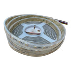 Coiled LED strip light with adhesive backing, showing multicolored SMD chips and attached power cable, product unboxing shot.