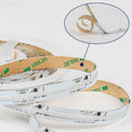 Coiled white and tan LED strip rolls displayed in spiral stacks, with close-up detail showing adhesive backing and electronic