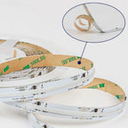 Coiled white and tan LED strip rolls displayed in spiral stacks, with close-up detail showing adhesive backing and electronic