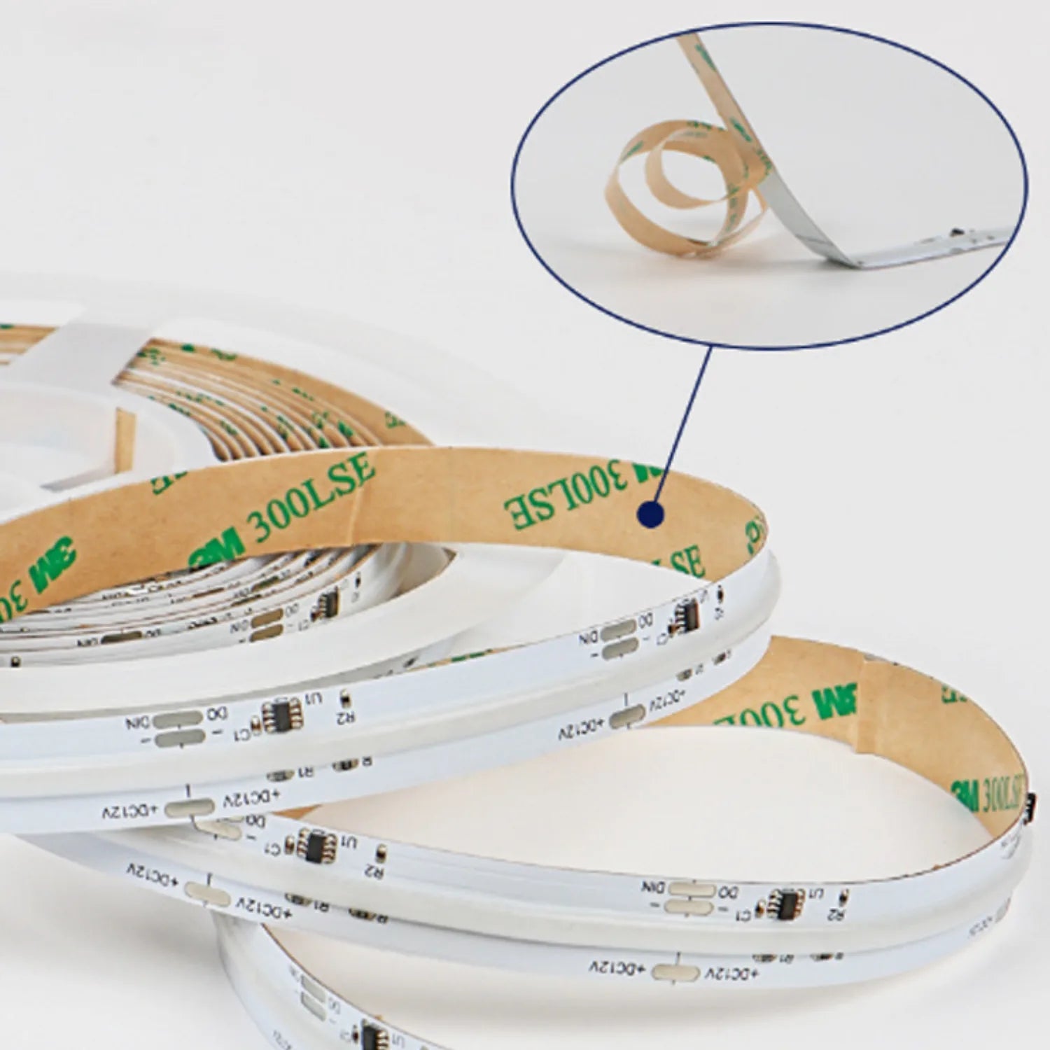 Coiled white and tan LED strip rolls displayed in spiral stacks, with close-up detail showing adhesive backing and electronic