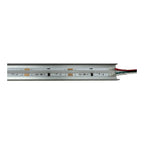 Top-down view of a 24V LED strip with aluminum housing, circuit components, and red and black power wires attached.