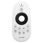 Mi-Light white remote control with black center dial, four zone buttons numbered 1-4, and on-off switches at top.