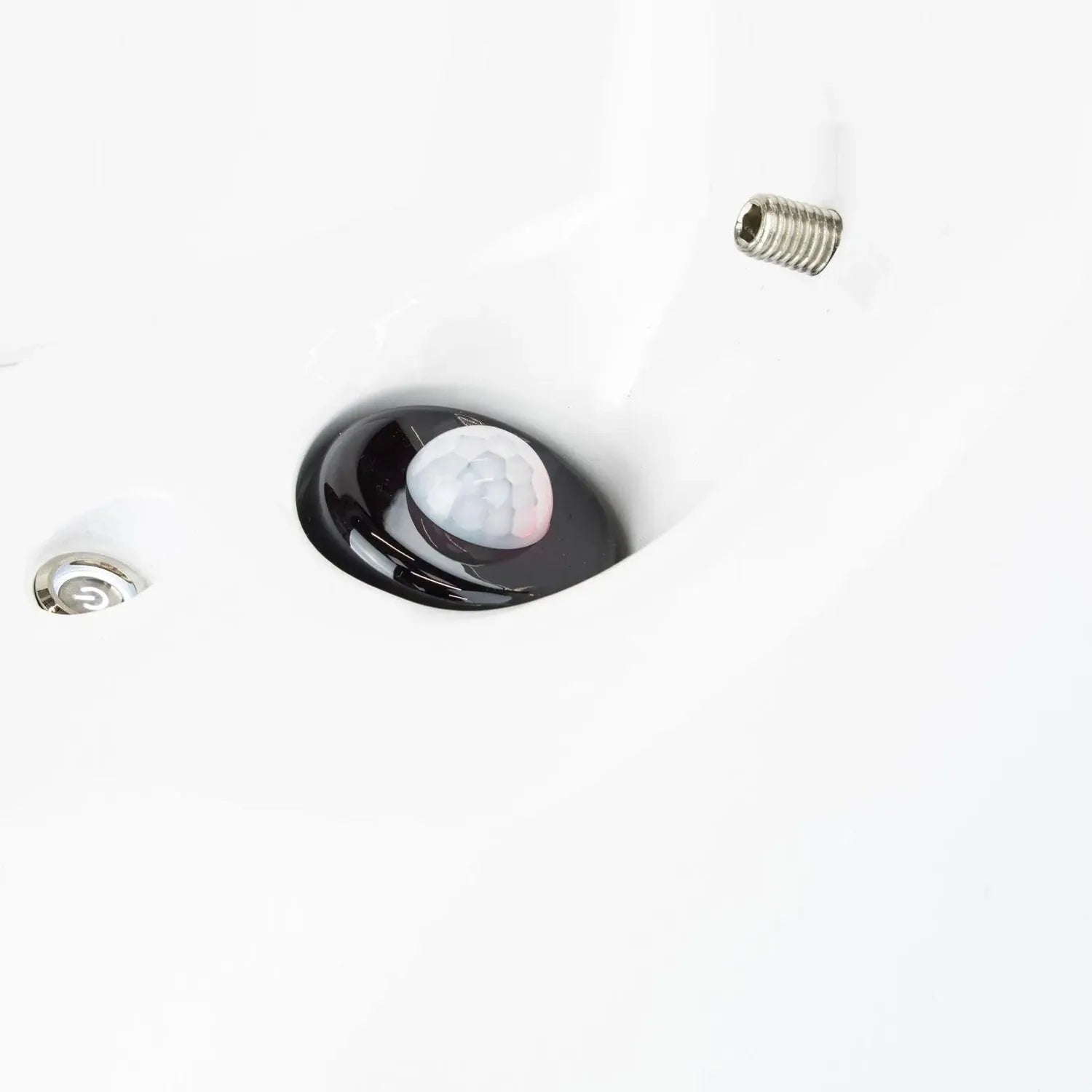 Black motion sensor light with white lens mounted in white ceiling, shown with mounting screw and installation hardware.