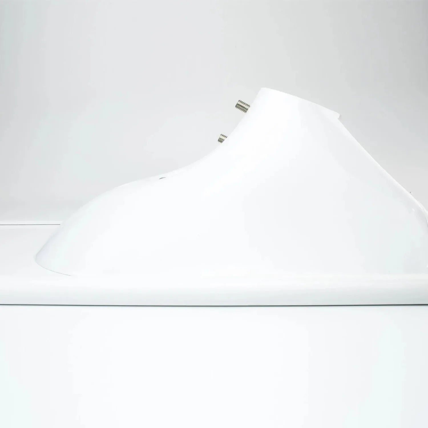 White solar LED street light mounted on pole, side view showing curved reflector design and mounting hardware.