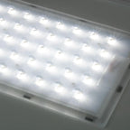 White rectangular LED panel with multiple bright light units mounted on ceiling, showing installation shot of solar street li
