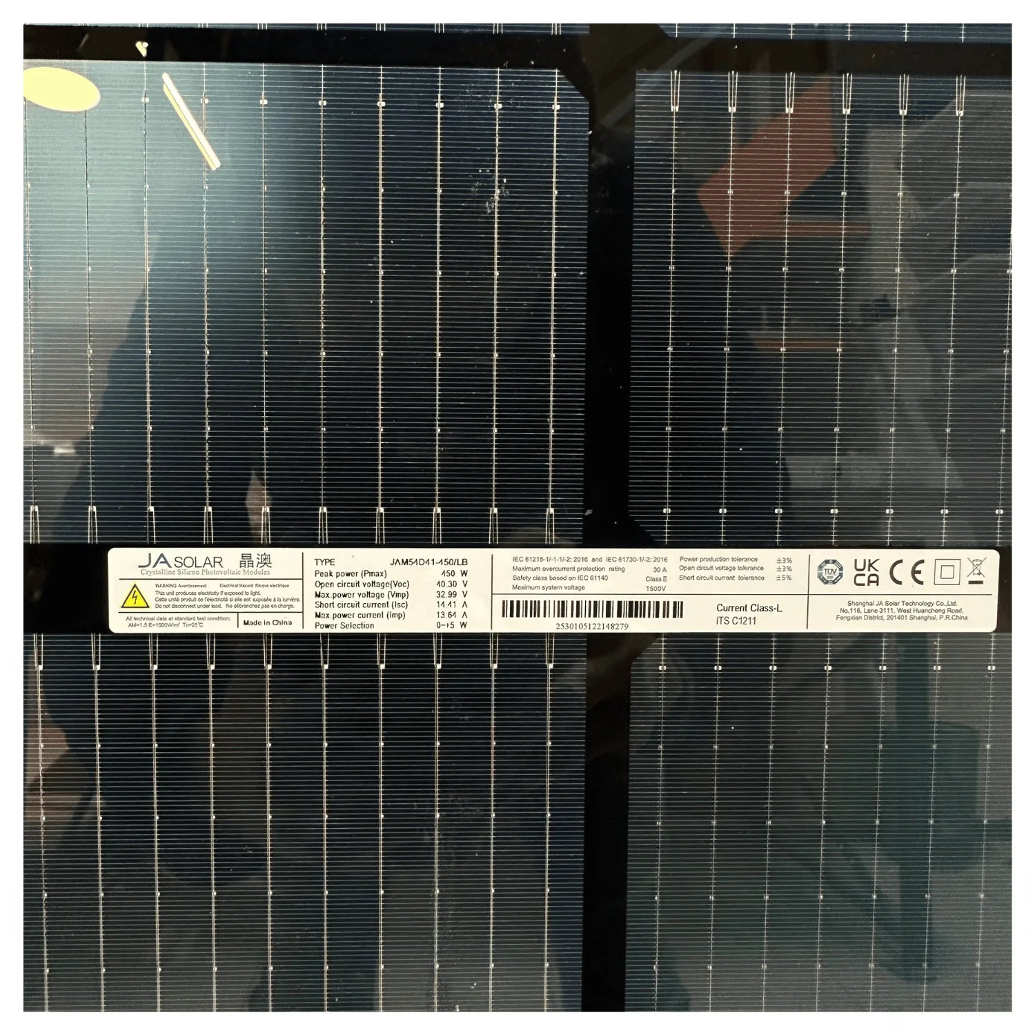 JA Solar 450-watt bifacial solar panel front surface showing grid pattern with metallic contacts and product label with speci