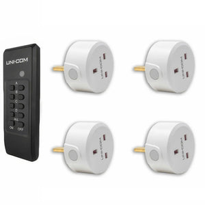 UNI-COM remote control kit with black transmitter and four white plug-in receiver sockets arranged in grid layout.