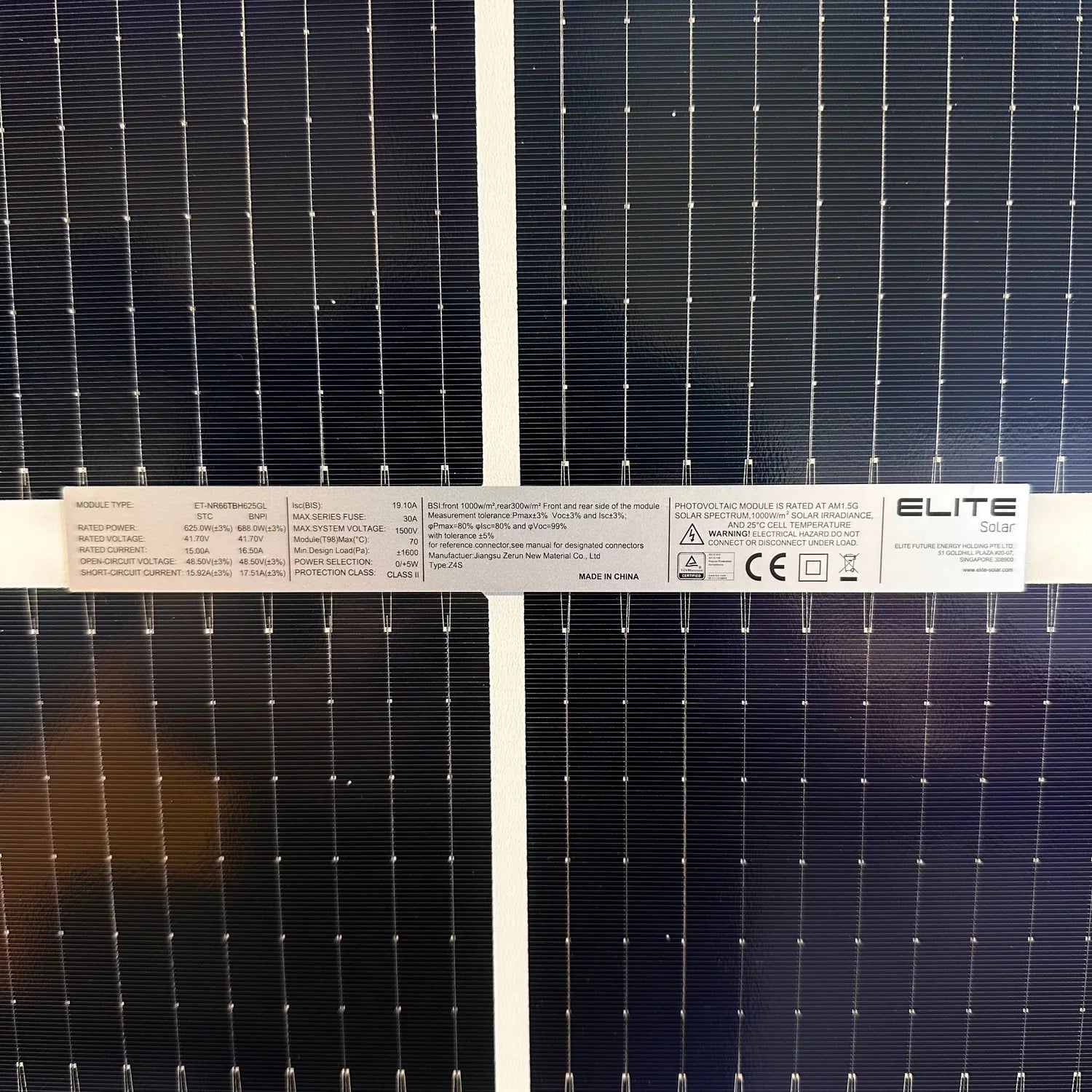 Close-up of four bifacial solar panels showing front and rear sides with white gridlines and connector points, specifications