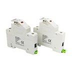 Two white modular DC solar fuse holders with red indicator lights and green terminal blocks, shown from front angle view.