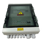 Solar PV combiner box with clear polycarbonate cover showing internal circuit breakers and terminals, mounted on white base w