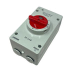 Red and white DC isolator switch with 32A rating mounted on gray weatherproof enclosure box.