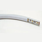 Curved aluminum LED profile strip with integrated LED components and connector ports visible on the end section, shown agains