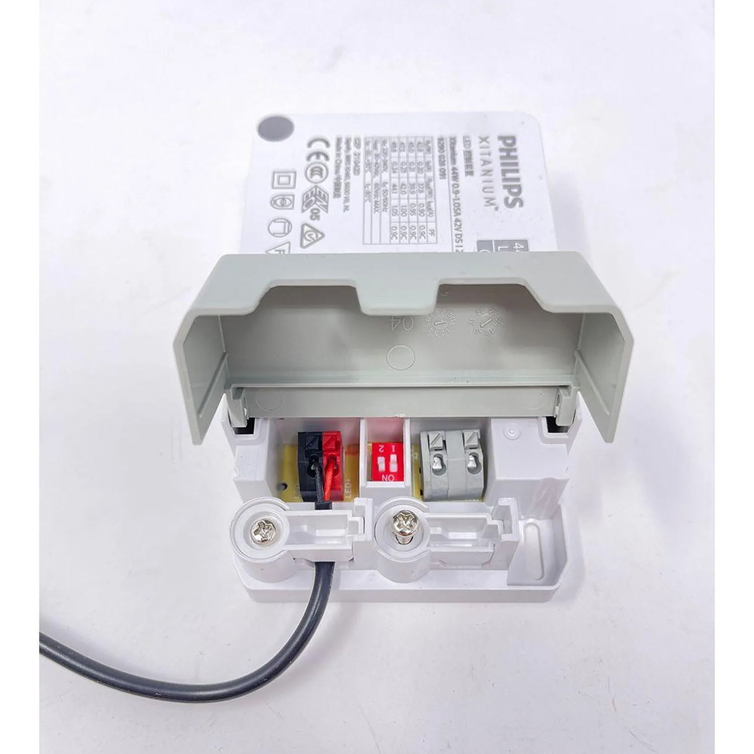 Philips LED driver interior view showing circuit components, terminals, and safety markings with open cover exposing wiring c