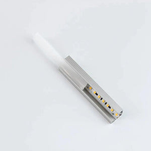 Silver aluminum LED profile with integrated warm white LEDs and opal diffuser cover, shown at an angle on white background.