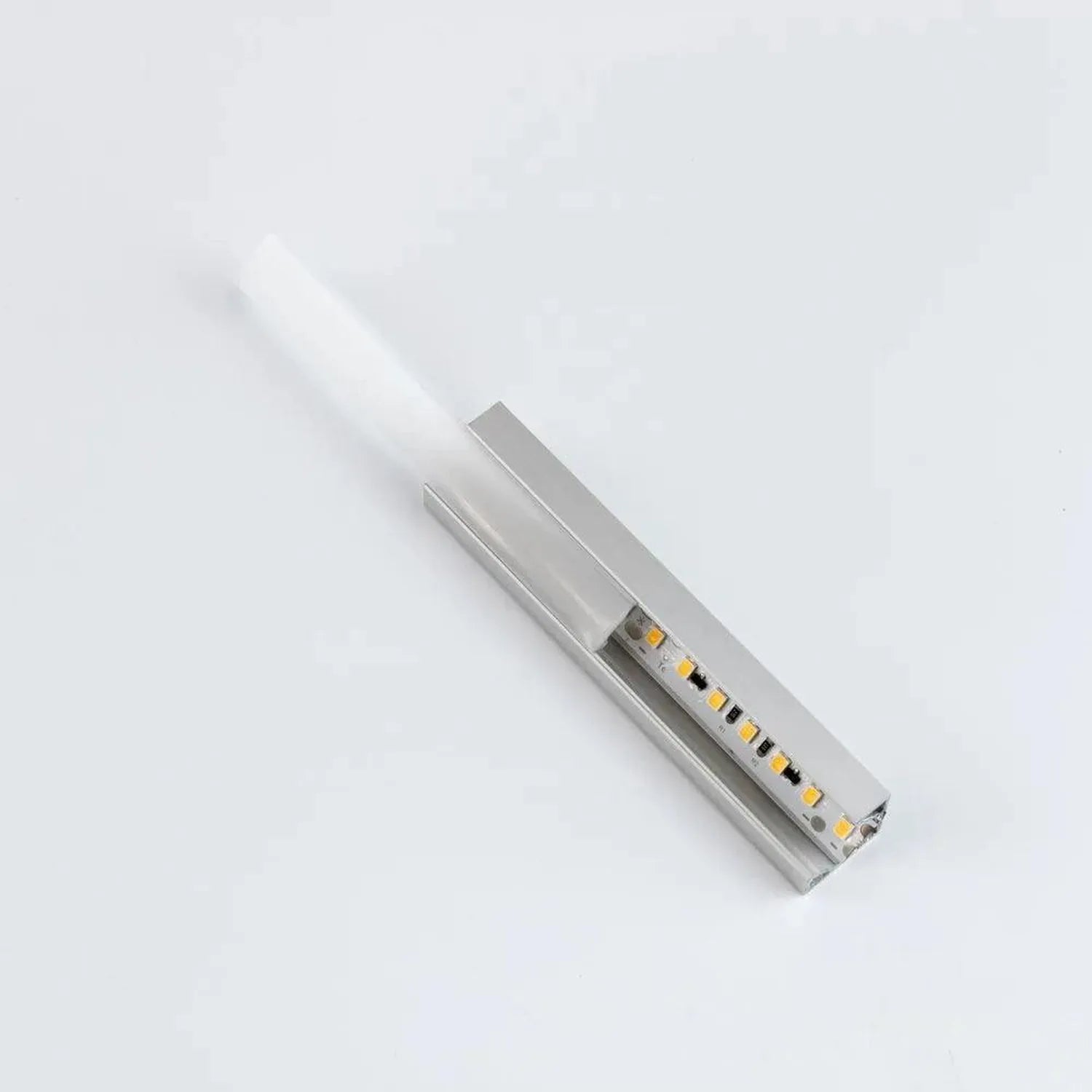 Silver aluminum LED profile with integrated warm white LEDs and opal diffuser cover, shown at an angle on white background.