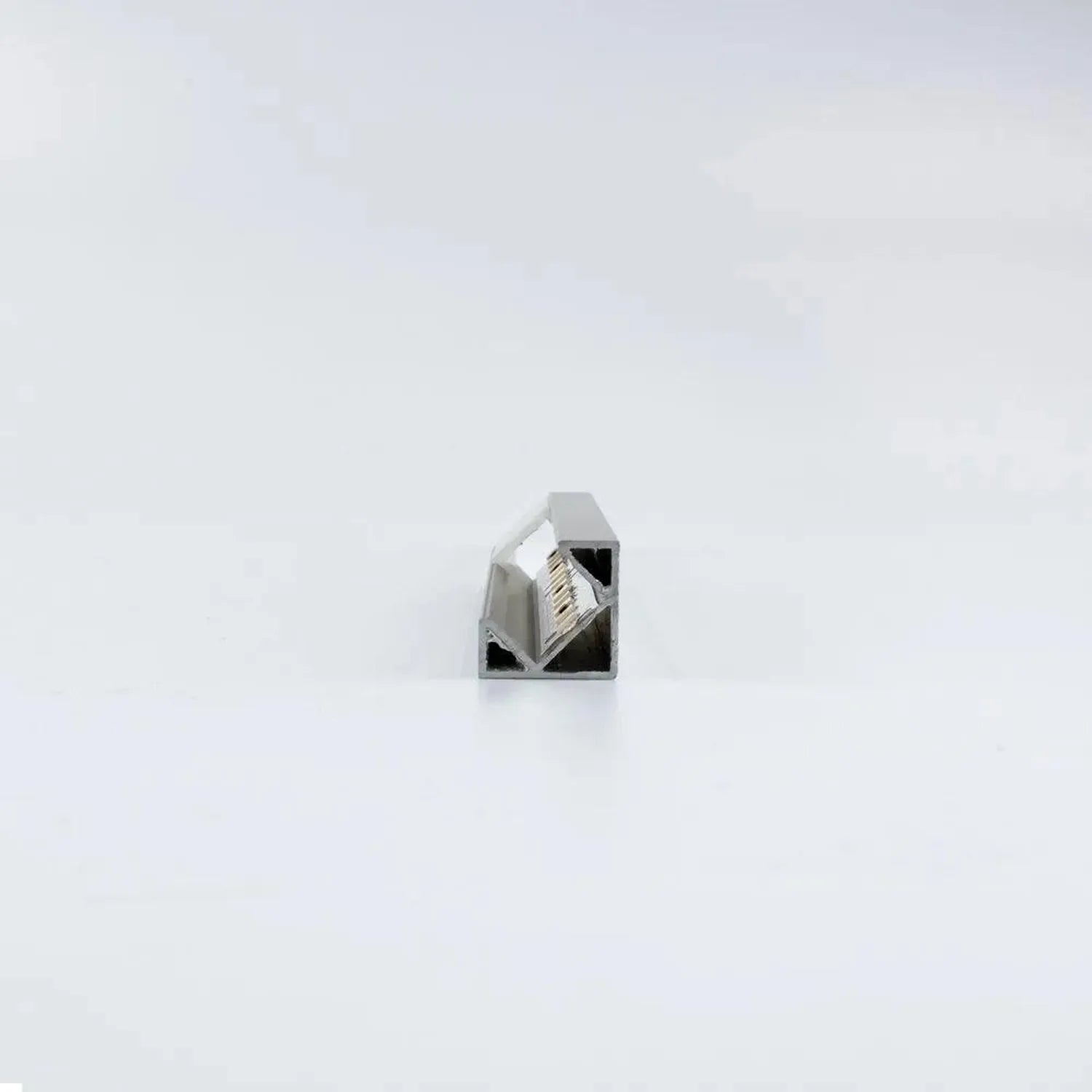 Gray aluminum corner profile with opal diffuser cover, showing internal LED strip mounting, isolated on white background.