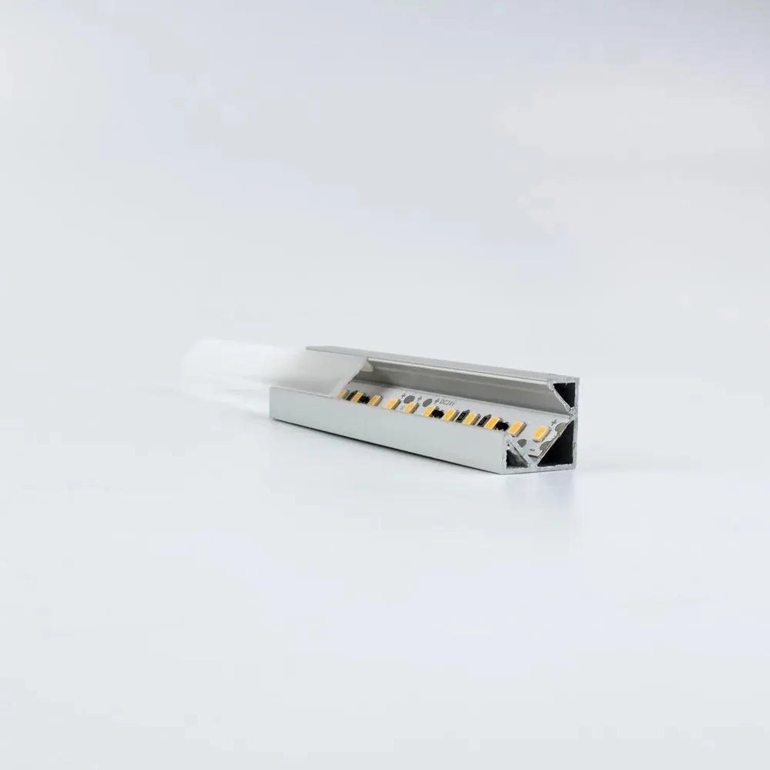 Open aluminum LED profile corner unit showing internal wiring and connector terminals against white background.