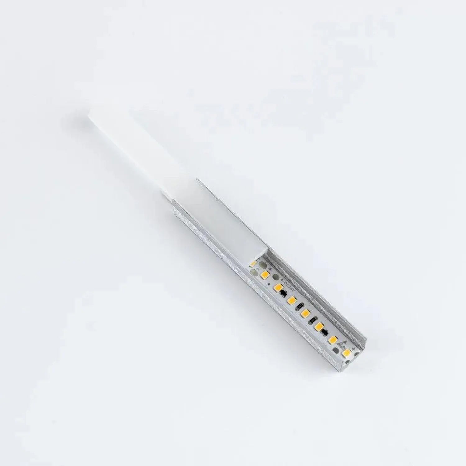 Aluminium U channel LED profile with integrated yellow LEDs mounted on white frosted diffuser, angled view on white backgroun