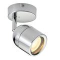 Polished chrome cylindrical LED spotlight with adjustable swivel head mounted on circular ceiling plate, illuminated warm whi