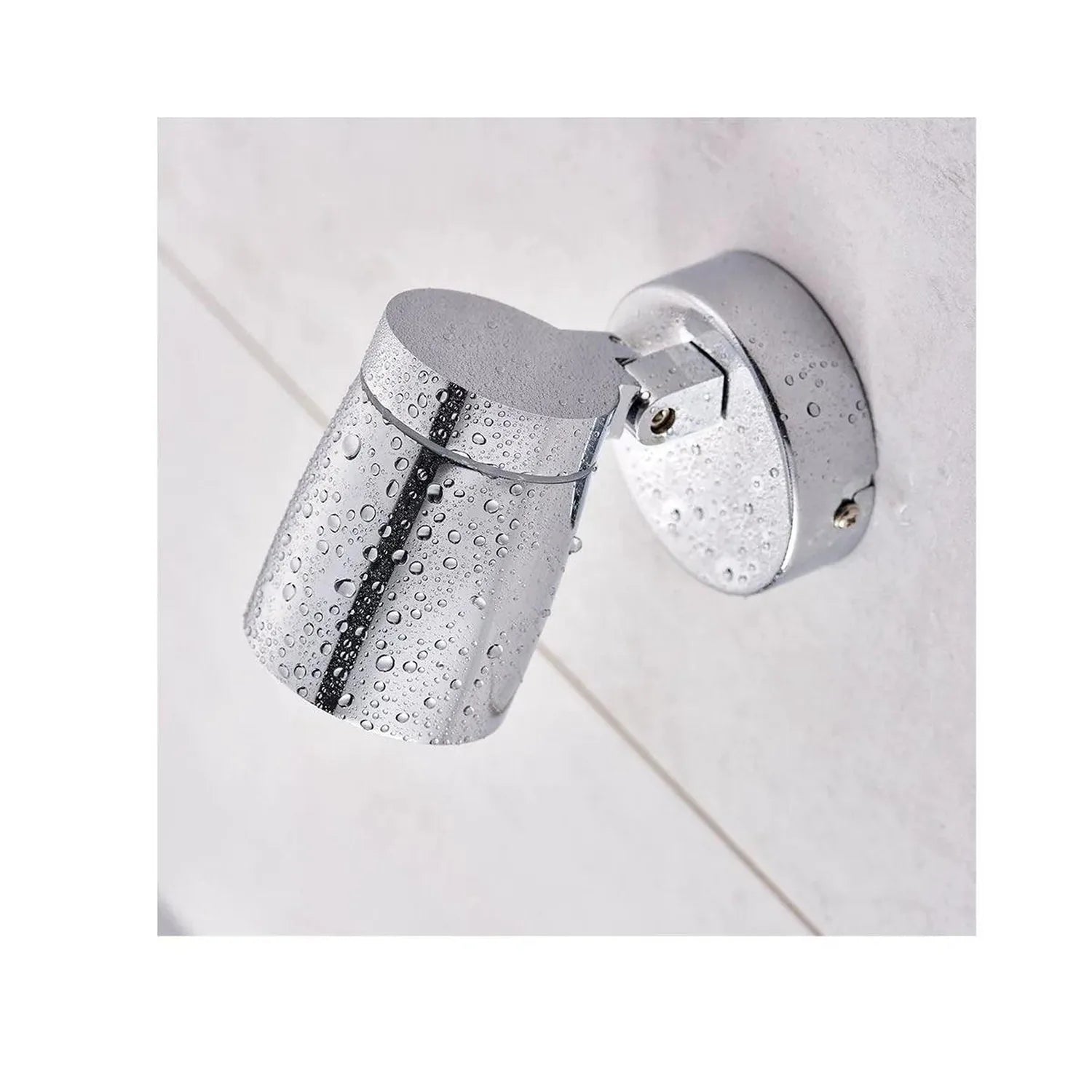 Polished chrome bathroom spotlight mounted on white ceiling with water droplets covering the fixture, demonstrating IP44 wate