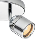 Chrome cylindrical spotlight with warm LED glow, mounted on curved ceiling bracket, shown against white background.