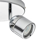 Chrome cylindrical spotlight with adjustable arm mounted on curved ceiling plate, showing LED lens detail.