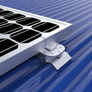 White mounting pad with bolt holes securing solar panel to blue corrugated metal roof, installation shot.