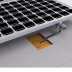 Solar panel mounting bracket installed on slate roof tile with aluminum rail and wood mounting base visible.