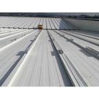 No-Drill Solar Panel Mounting Kit installed on metal roof with bonded rails running parallel across white corrugated panels, 