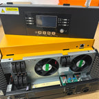 Open yellow case showing interior of 5kW solar inverter with dual cooling fans, circuit boards, and terminal connections visi