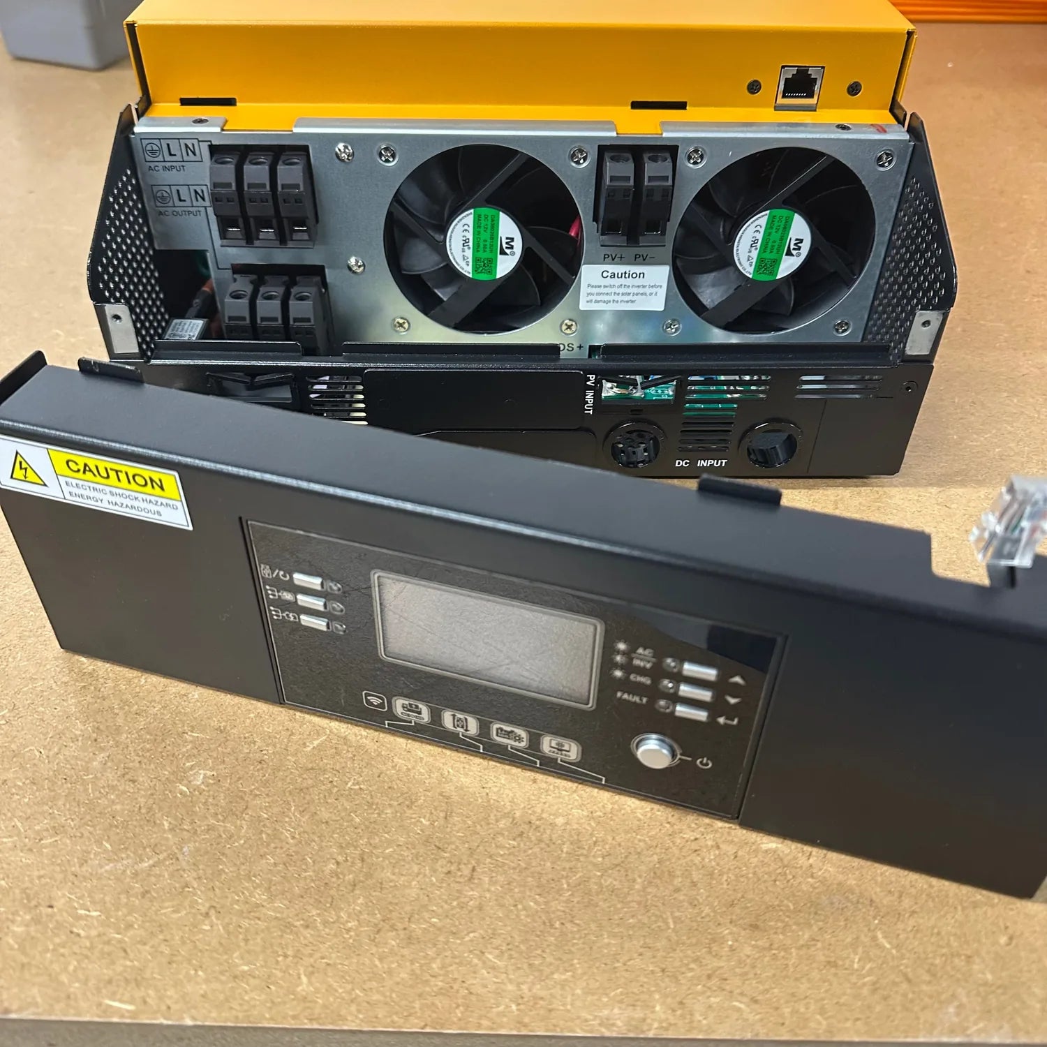 Refurbished 5kW solar inverter charger with yellow top unit showing dual cooling fans, control panel below with LCD display a