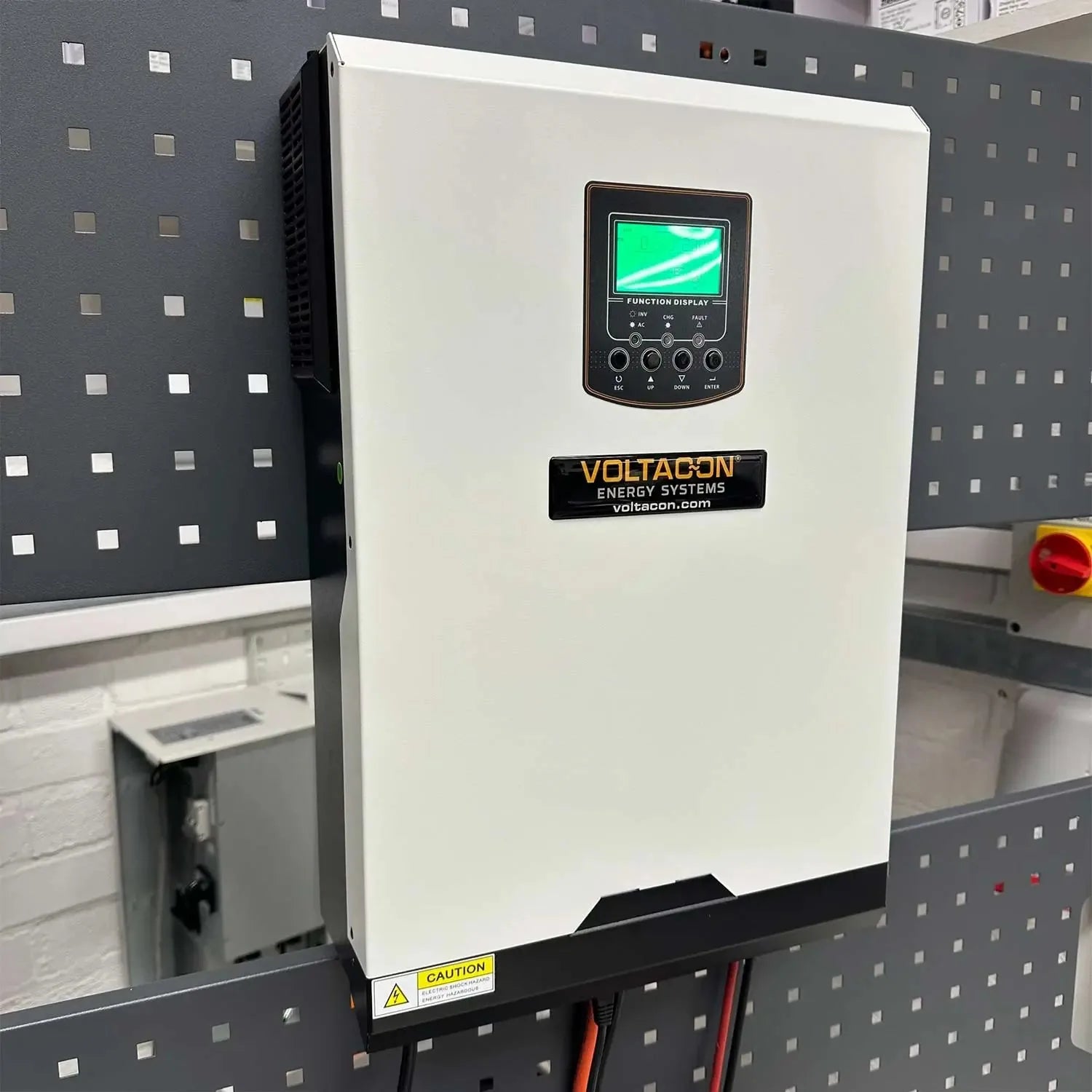 Voltacon Energy Systems 5kW 48V off-grid solar inverter mounted on pegboard, white case with green function display screen an