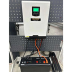 Voltacon 5kW inverter installed in white cabinet above Pylontech battery and US5000 power management system on perforated wal