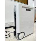 Voltacon Energy Systems portable power station with white cylindrical body and wheels, displayed in an indoor setting on tile