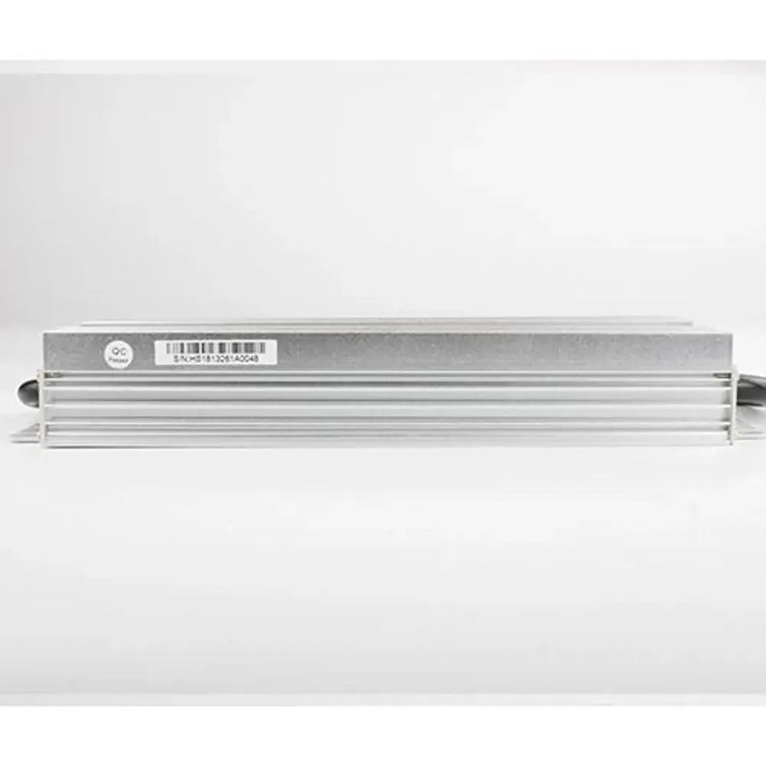Glacial LED driver, aluminum rectangular unit with ventilation fins, barcode label visible on top, side view product shot.